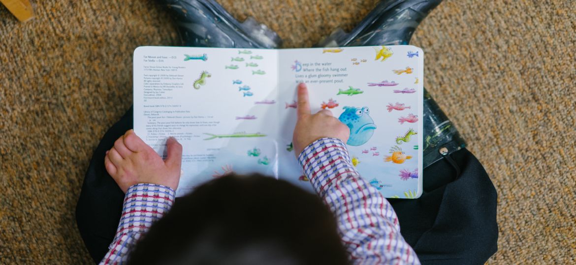 photo-of-a-boy-reading-book-1250722